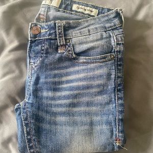Size 24L, medium wash, form fitting skinny jeans.